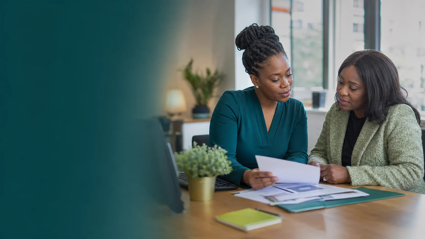 Ashabee adviser helping a client review travel documents